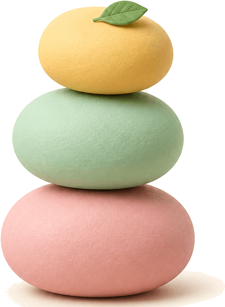 Three balanced clay stones stacked with a leaf on top