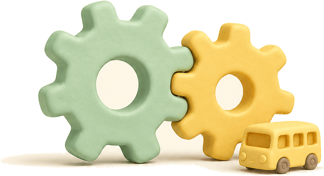 Two interlocking gears beside a small school bus